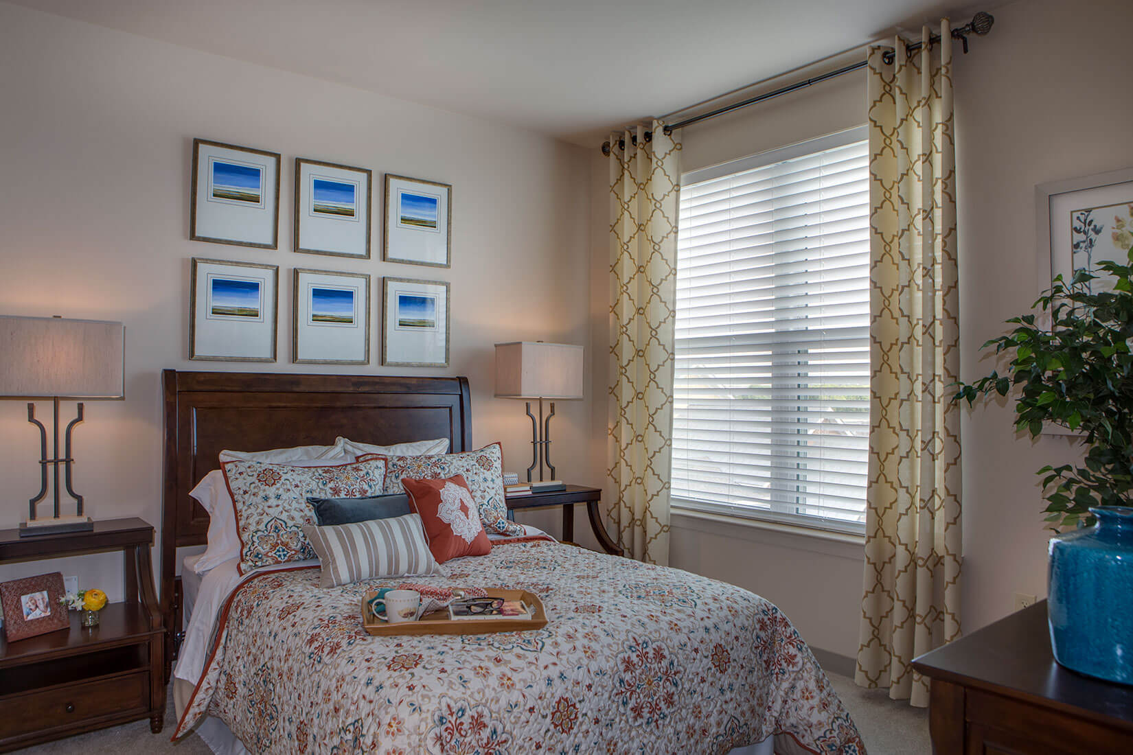 bedroom with two nightstands, bed, and elegant lighting