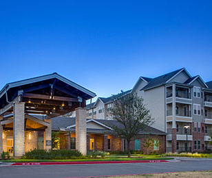 nighttime view of the entrance to The Delaney at Lake Waco