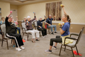 staff member leading an exercise with residents