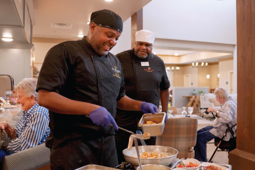 staff refilling food options in the dining hall